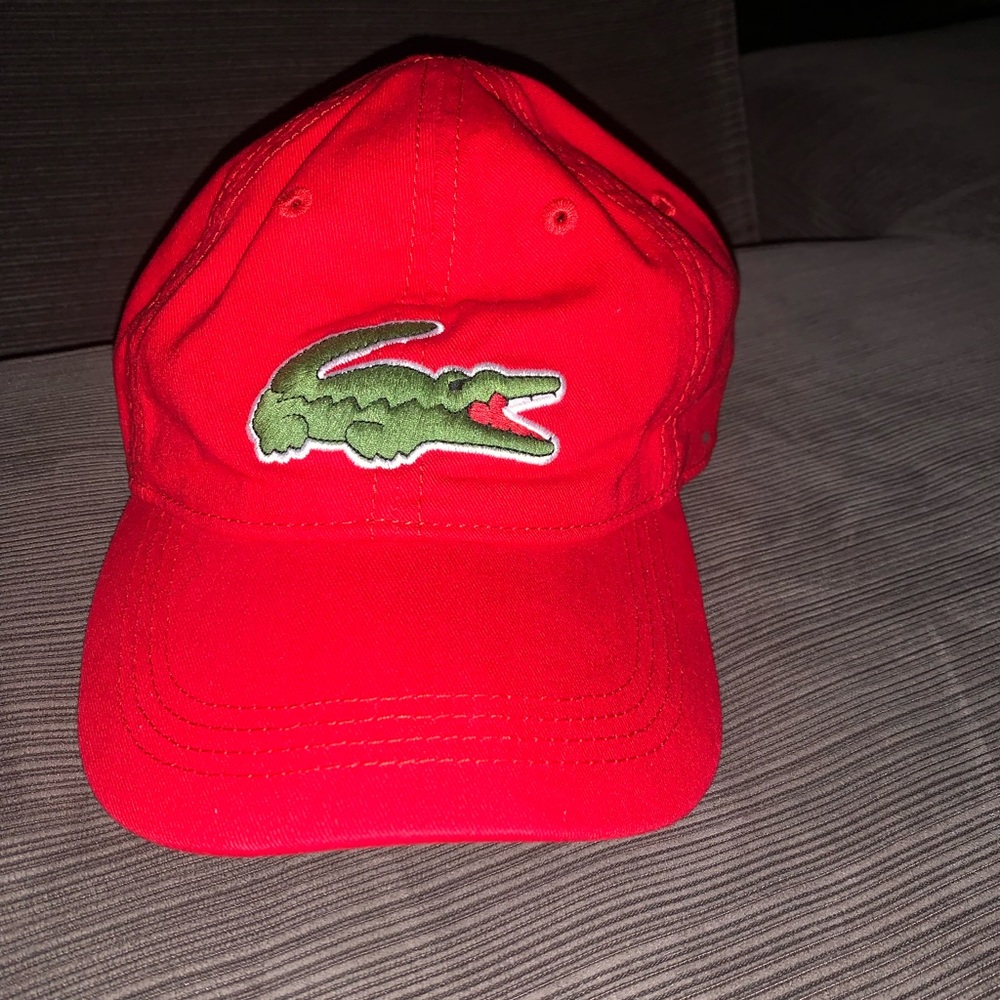 A red Lacoste baseball cap.